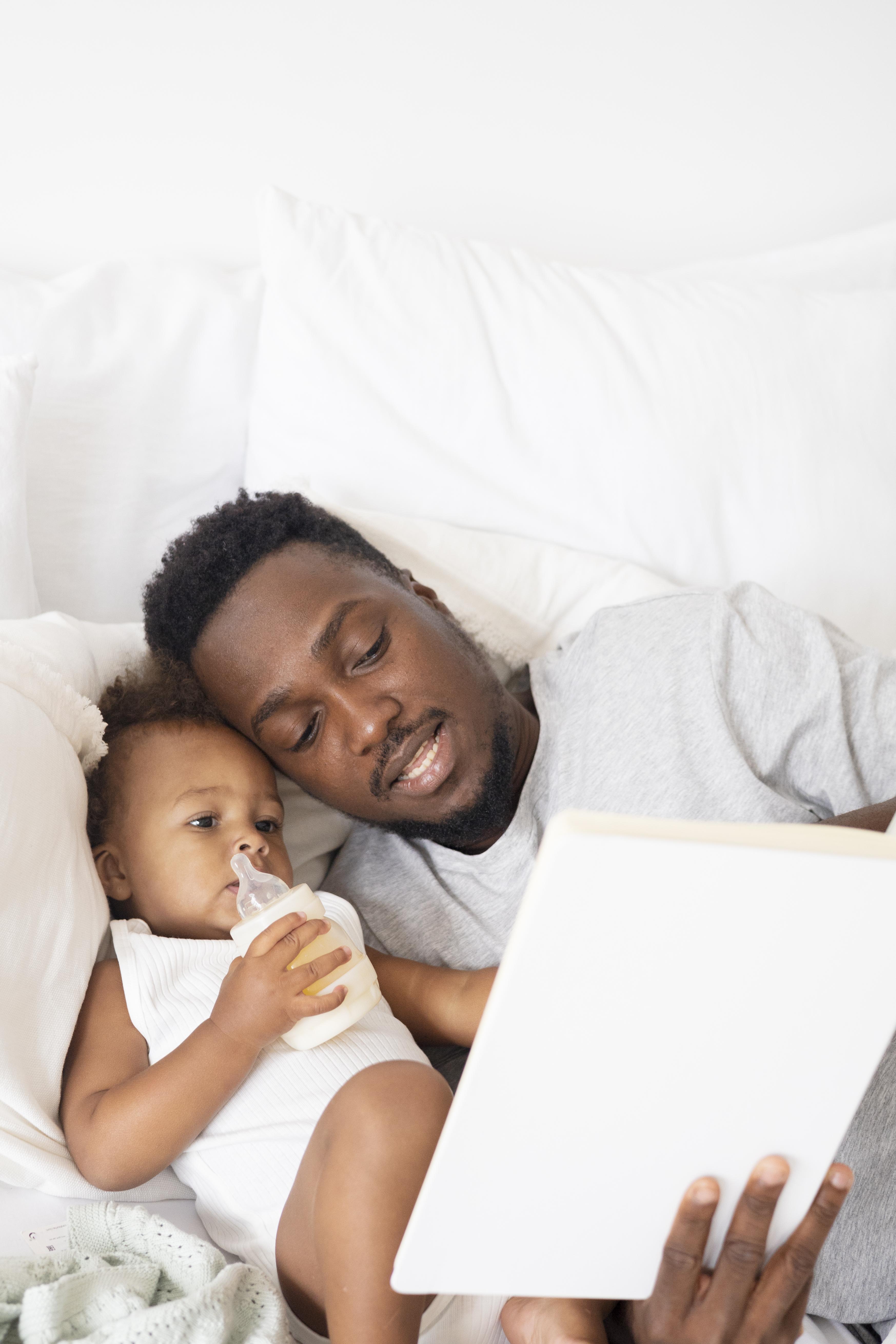 A parent reading a Yanai story with their child